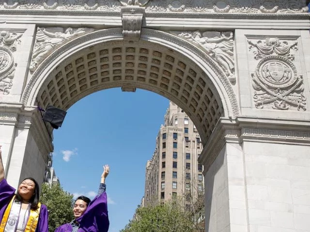 new york university graduates pose together under the washington square arch in washington square park in new york city u s may 13 2021 photo reuters