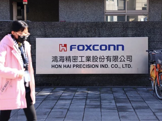 a woman walks past the logo of foxconn outside a company s building taipei taiwan photo reuter a woman walks past the logo of foxconn outside a company s building taipei taiwan photo reuter