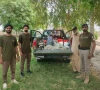 wildlife rangers stand beside a truck carrying confiscated items from poachers photo express