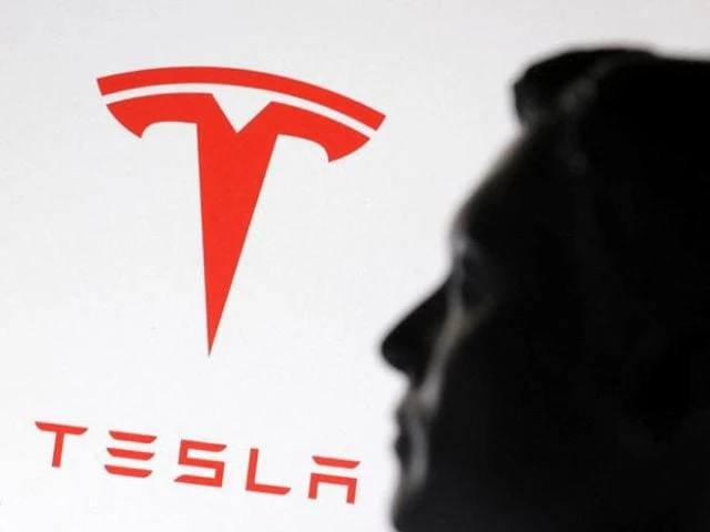 a 3 d printed miniature model of musk and tesla logo photo reuters a 3 d printed miniature model of musk and tesla logo photo reuters