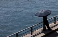 a person shelters from the sun under an umbrella along the banks of the river seine in paris as temperatures rise during a heatwave affecting a large part of france june 22 2026 photo reuters