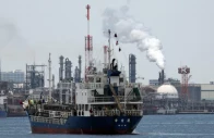 a small tanker sails near an oil refinery in the keihin industrial zone in kawasaki south of tokyo japan march 17 2026 photo reuters