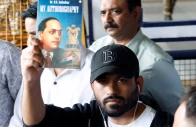 abhijeet dipke head of the cockroach janta party cjp holds a copy of my autobiography by dr b r ambedkar as he leaves an airport in new delhi india june 6 2026 photo reuters