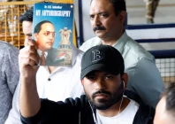 abhijeet dipke head of the cockroach janta party cjp holds a copy of my autobiography by dr b r ambedkar as he leaves an airport in new delhi india june 6 2026 photo reuters