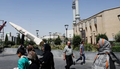 people walk next to a symbolic mock up of an iranian missile on a street in tehran iran june 11 2026 photo reuters