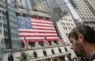people walk past the new york stock exchange nyse in new york city us on july 11 2025 picture taken through glass photo reuters