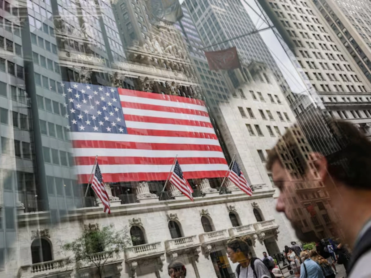 people walk past the new york stock exchange nyse in new york city us on july 11 2025 picture taken through glass photo reuters