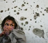 mohboba 7 stands near a bullet ridden wall in kabul as she waits to be seen at a health clinic in march 2002 photo afp