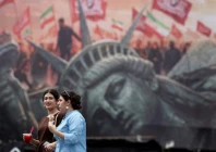 people walk past an anti us billboard on a street in tehran iran august 3 2026 photo reuters file