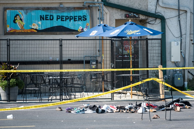 A couple mourn at a vigil for victims of the shooting in Dayton, Ohio, which killed nine people 13 hours after another gunman in El Paso, Texas, murdered 29 people. PHOTO: AFP