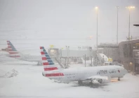 a boeing 737 american airlines passenger aircraft is parked at gate on the tarmac of laguardia airport in new york amid snowfall photo afp