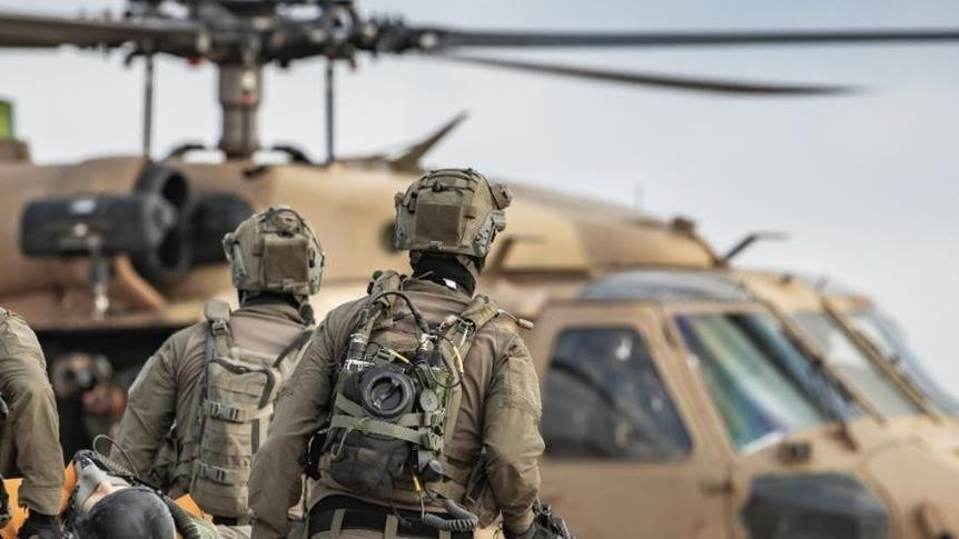 an image shows us troops with a chopper in the background photo anadolu