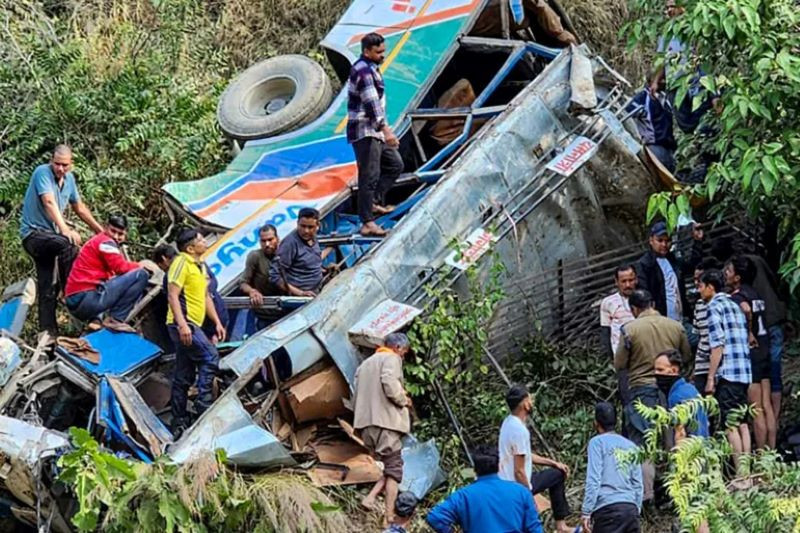 this handout photograph shows people at the site of a bus accident after it fell into a gorge at almora district in india s uttarakhand state photo afp