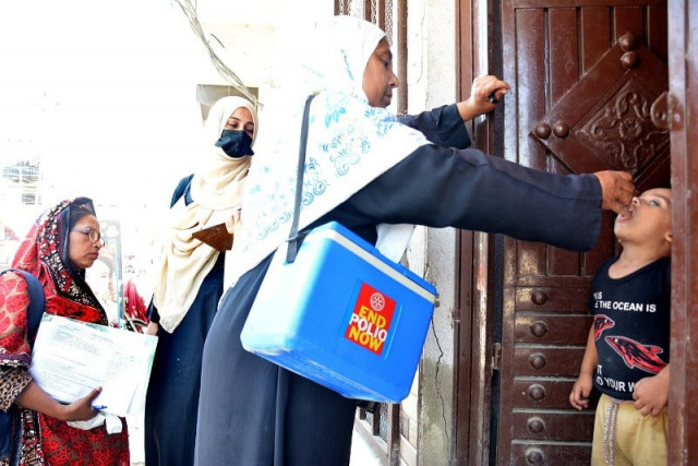 a vaccinator administers polio vaccine to a child in a karachi neighbourhood during the anti polio drive which kicked off on monday photo express a vaccinator administers polio vaccine to a child in a karachi neighbourhood during the anti polio drive which kicked off on monday photo express