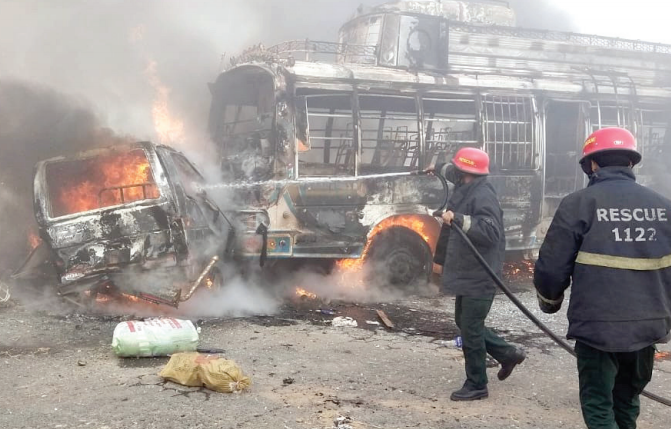 rescuers try to extinguish fire that erupted after a van bus collision near narang mand photo express