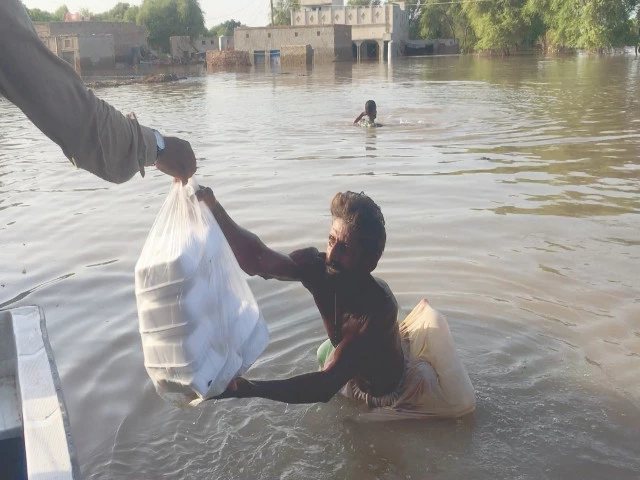 a flood hit man in kabirwala collects relief supplies photo express