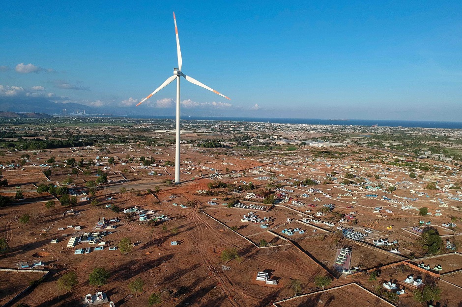 A wind turbine built on the grounds of a cemetery at the Phu Lac wind farm in southern Vietnam's Binh Thuan province. PHOTO: AFP