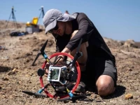 a vulcanologist from the university of munich prepares a drone with a mirror used to reflect a laser and collect data from gas emissions in the crater of la fossa italy photo afp