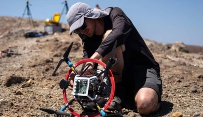 a vulcanologist from the university of munich prepares a drone with a mirror used to reflect a laser and collect data from gas emissions in the crater of la fossa italy photo afp
