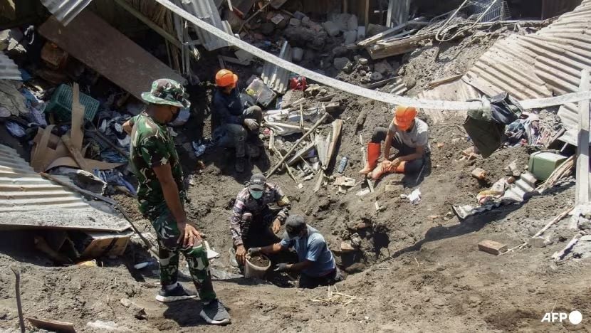 rescuers carry away victims of a volcanic eruption in eastern indonesia arnold welianto afp