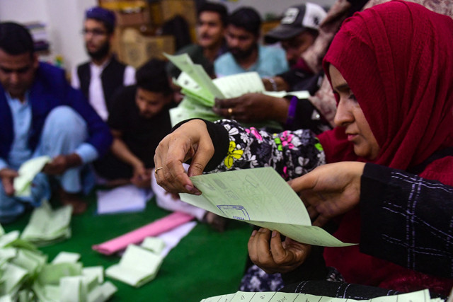 polling staff start counting votes as polls end during country s national elections in karachi on february 8 2024 photo afp