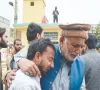 an elderly man tries to comfort his younger companion shattered by the death of loved ones in a suicide attack at an imambargah in islamabad photo reuters