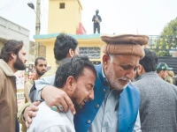 an elderly man tries to comfort his younger companion shattered by the death of loved ones in a suicide attack at an imambargah in islamabad photo reuters