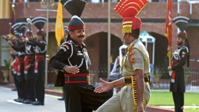 in this photograph taken on august 1 2022 an indian border security force bsf soldier c and a pakistani ranger perform during the beating the retreat ceremony at the pakistan india wagah border post photo afp in this photograph taken on august 1 2022 an indian border security force bsf soldier c and a pakistani ranger perform during the beating the retreat ceremony at the pakistan india wagah border post photo afp