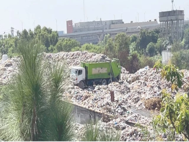 rwmc vehicles load solid waste from the children s park turned dump in liaquat bagh which has caused a permanent foul smell to linger in the surrounding areas photo express rwmc vehicles load solid waste from the children s park turned dump in liaquat bagh which has caused a permanent foul smell to linger in the surrounding areas photo express