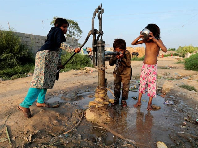 children drink water from a hand pump in a slum in islamabad pakistan photo reuters