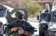 a member of the israeli force stands guard as the israeli forces block the access of palestinians and foreign activists to olive trees during the olive harvest near hebron in the israeli occupied west bank october 23 2025 photo reuters