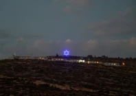 an illuminated star of david above an israeli settlers outpost near ramallah in the israeli occupied west bank august 14 2026 reuters