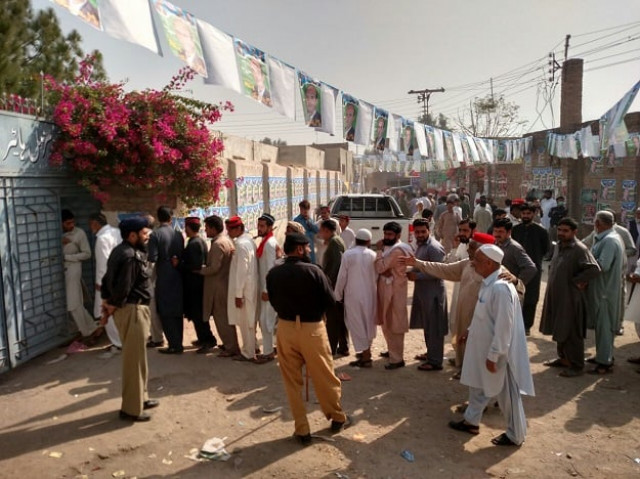 male polling station of government shaheed muzamil higher secondary school chamkani police searching voter for cell phones as cell phones have been banned in the premises of all polling stations photo express male polling station of government shaheed muzamil higher secondary school chamkani police searching voter for cell phones as cell phones have been banned in the premises of all polling stations photo express