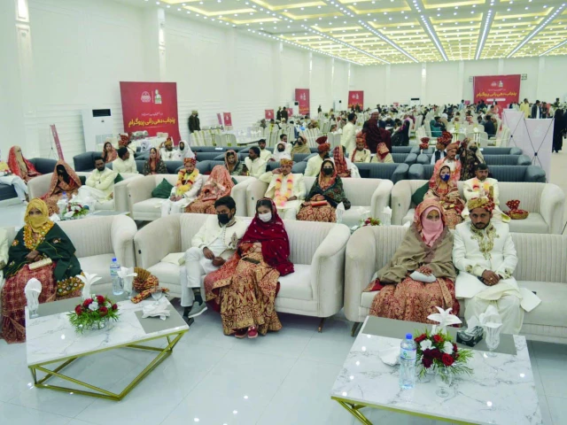 under the punjab government s dhee rani programme newlywed couples sit together under a grand marquee during a mass wedding ceremony photo express