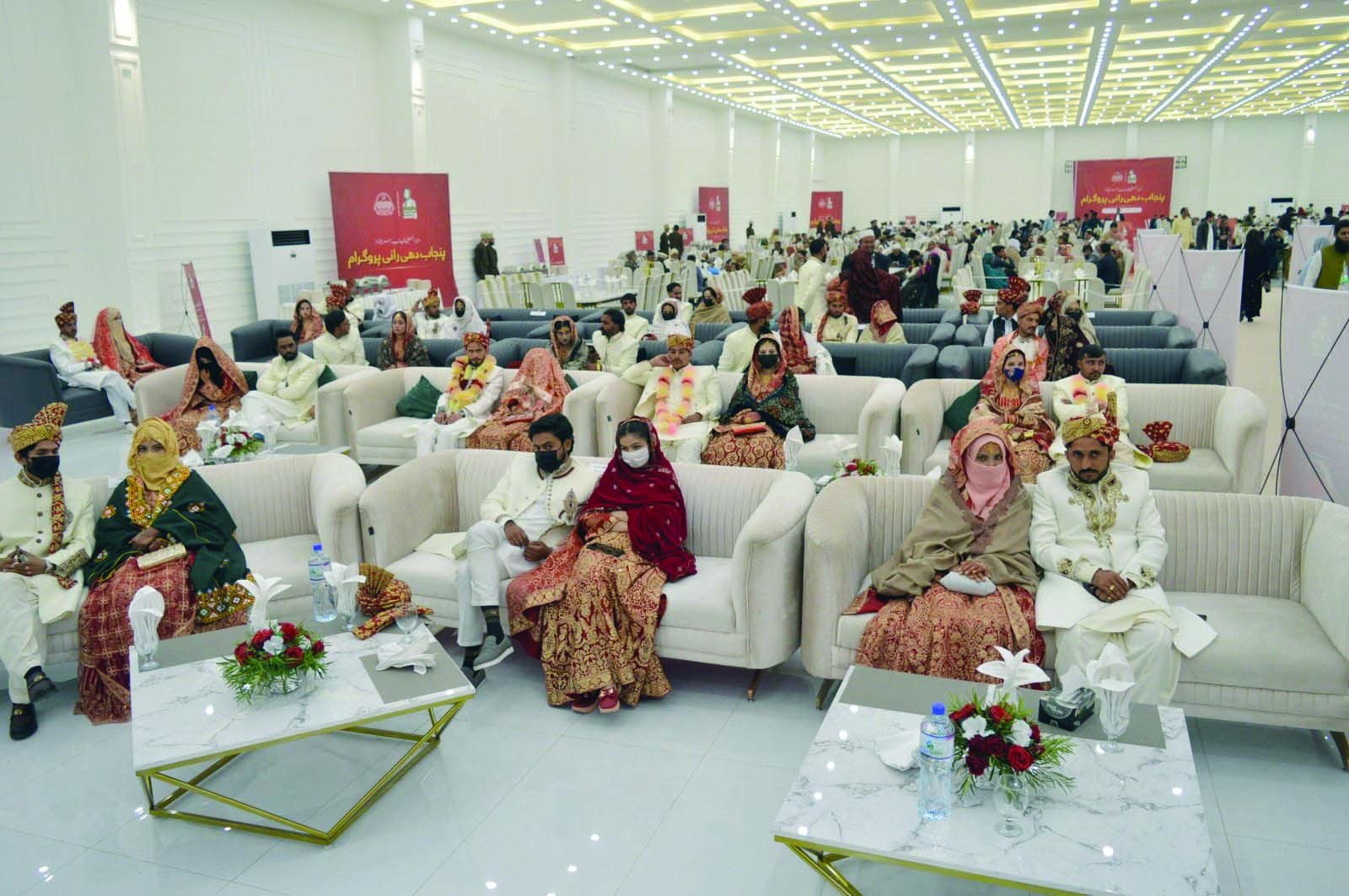 under the punjab government s dhee rani programme newlywed couples sit together under a grand marquee during a mass wedding ceremony photo express