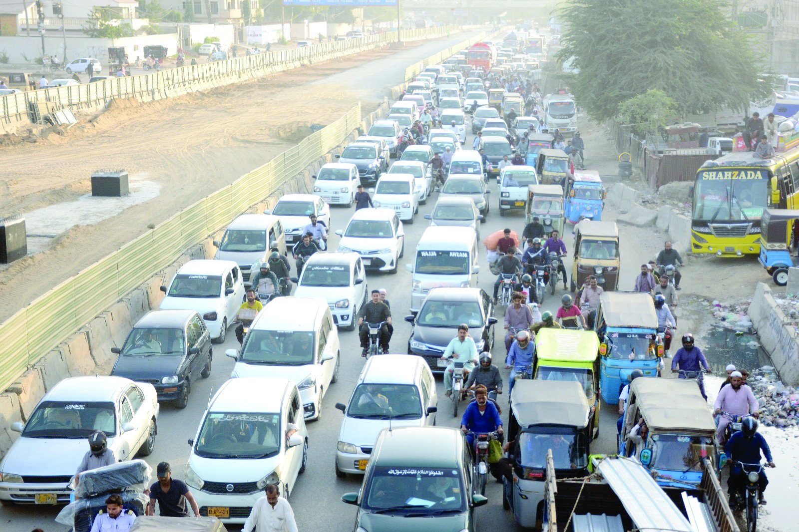 unlike the tradition of yore office workers in the metropolis rarely get to enjoy iftar at home with family commuters stuck on the dug up university road are waiting for the siren to announce the end of the fast in the slow moving traffic photo jalal qureshi express