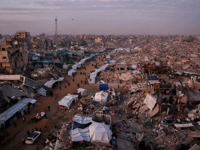 palestinians walk through rubble in gaza photo afp palestinians walk through rubble in gaza photo afp