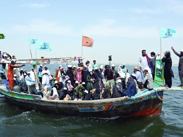 fisherfolk forum activists stage a protest on a boat against the proposed new canals on the indus river which they claim would damage the coastal ecosystem photo express