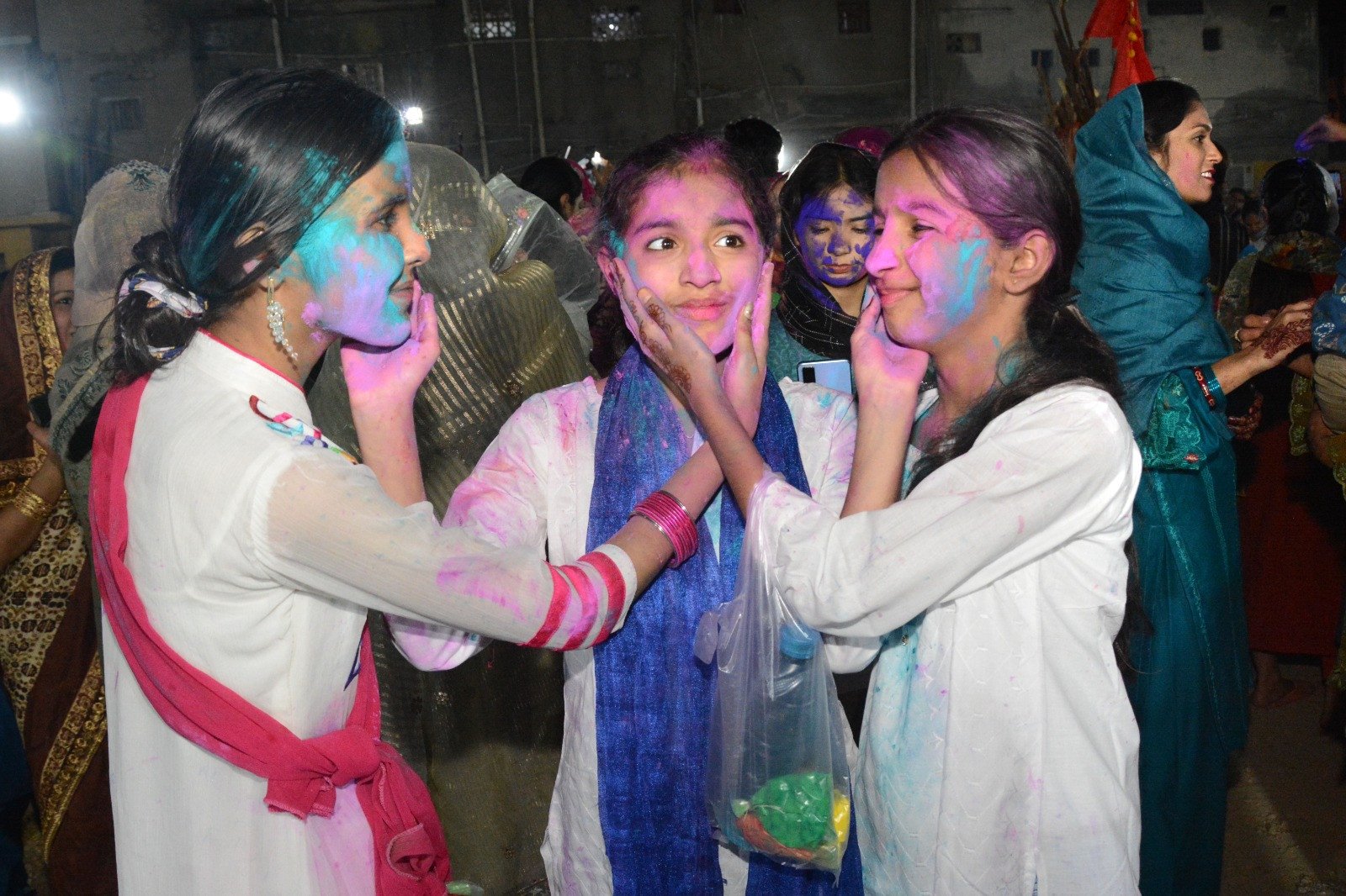 festival of colours young girls smear colour on each other as part of holi celebrations at the swaminarayan mandir in karachi photo express