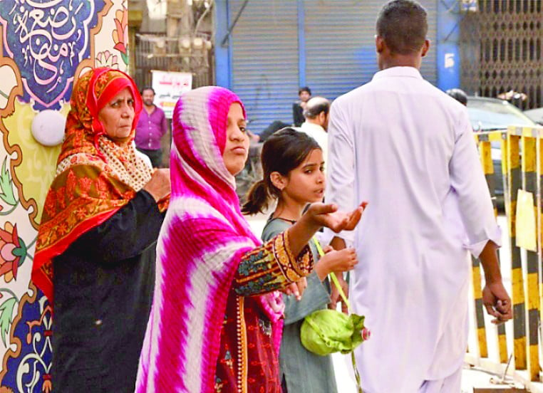 a family of professional beggars seeks alms in a hyderabad market ramazan and eid bring thousands of panhandlers to cities to exploit the spirit of charity while depriving the deserving ones who won t beg in bazaars photo express