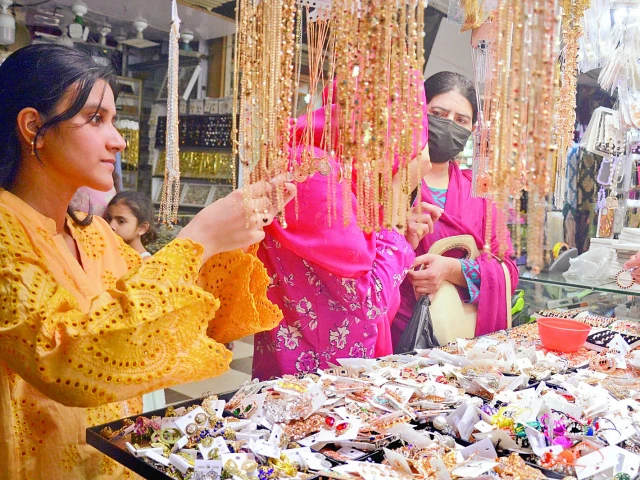 women select accessories at a market in the city for the upcoming festive occasion of eidul fitr photo jalal qureshi express women select accessories at a market in the city for the upcoming festive occasion of eidul fitr photo jalal qureshi express