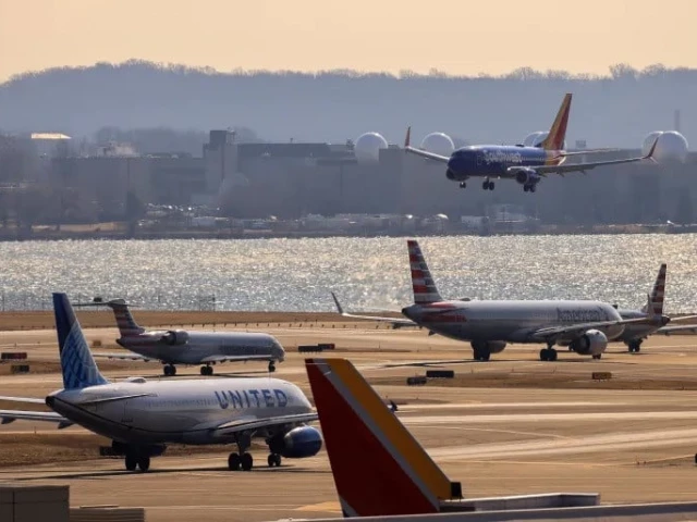 a plane prepares to land as other planes wait their turn to take off on a busy runway at the ronald reagan washington national airport in arlington virginia photo reuters a plane prepares to land as other planes wait their turn to take off on a busy runway at the ronald reagan washington national airport in arlington virginia photo reuters