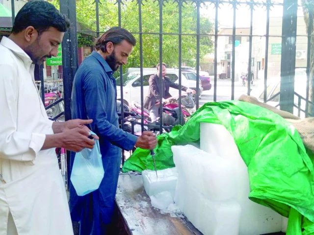 amid soaring temperatures and increasing demand for ice a customer purchases ice from a street vendor in rawalpindi s open market ice is being sold at rs40 per kilogramme photo express