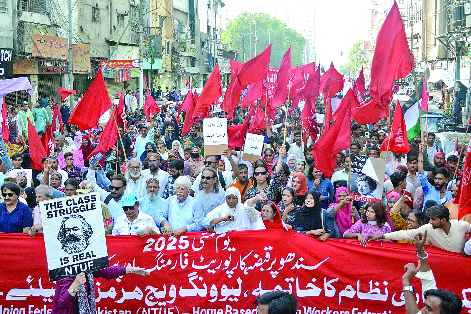 participants of the rally pass through zaibunnisa street carrying banners and flags demanding a just and fair homeland photo jalal qureshi express participants of the rally pass through zaibunnisa street carrying banners and flags demanding a just and fair homeland photo jalal qureshi express