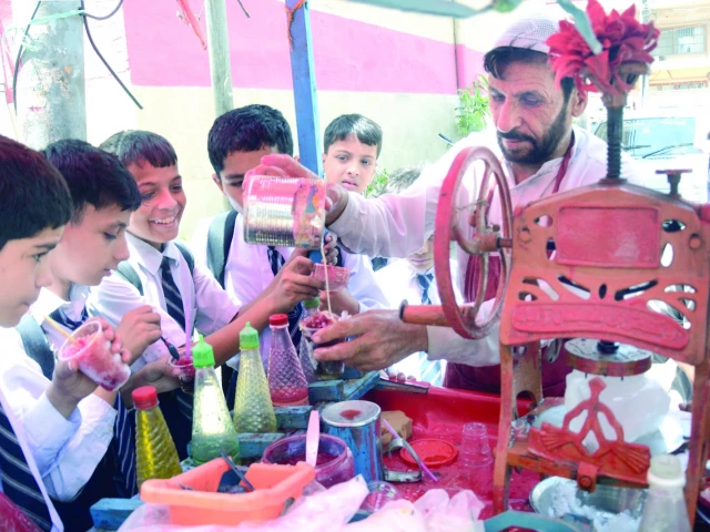 children enjoy colourful shaved ice balls topped with condensed milk outside their school on a very hot day in the city on tuesday photo jalal qureshi express children enjoy colourful shaved ice balls topped with condensed milk outside their school on a very hot day in the city on tuesday photo jalal qureshi express
