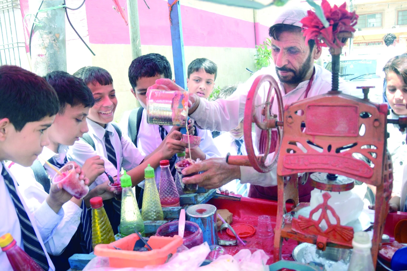 children enjoy colourful shaved ice balls topped with condensed milk outside their school on a very hot day in the city on tuesday photo jalal qureshi express children enjoy colourful shaved ice balls topped with condensed milk outside their school on a very hot day in the city on tuesday photo jalal qureshi express