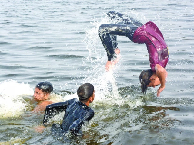 a boy somersaults in the shallow water under the native jetty bridge on an extremely hot and humid day in the city on tuesday photo jalal qureshi express a boy somersaults in the shallow water under the native jetty bridge on an extremely hot and humid day in the city on tuesday photo jalal qureshi express