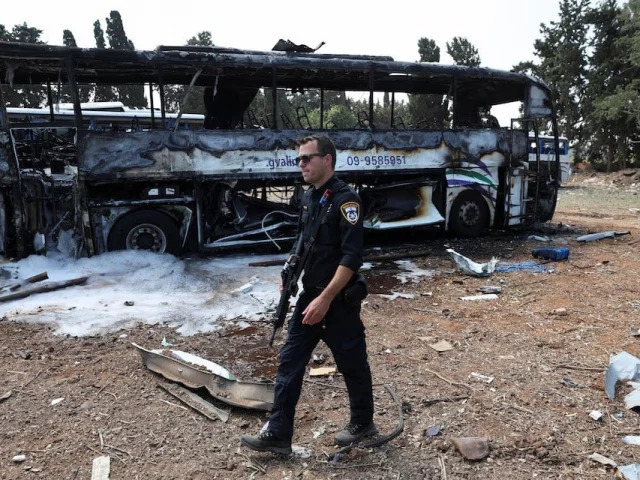 a police officer walks past a burnt out bus following a missile attack from iran in herzliya israel june 17 2025 photo reuters a police officer walks past a burnt out bus following a missile attack from iran in herzliya israel june 17 2025 photo reuters