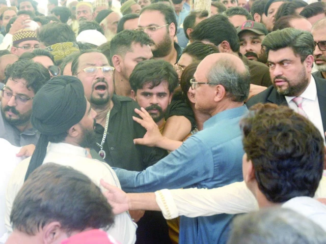 overwhelmed by sorrow qawwal majid ali sabri breaks down at the funeral of his brother nephew and a fellow troupe member while ppp s saeed ghani governor kamran tessori of mqm p and pti s haleem adil sheikh stand united in condolence photo jalal qureshi express