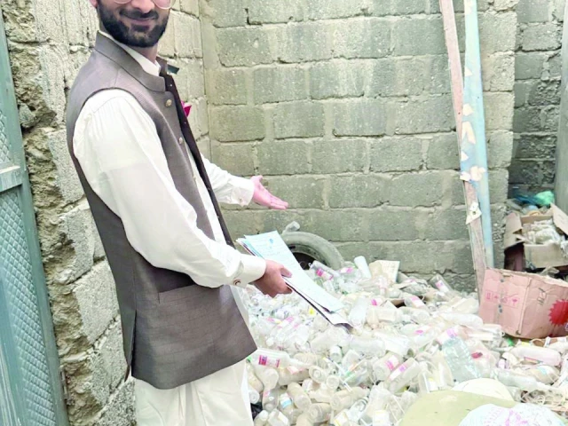 assistant director of shcc ahmer abbas saldera stands beside a pile of discarded empty beauty drips at an illegal aesthetic clinic in dha phase ii photo express